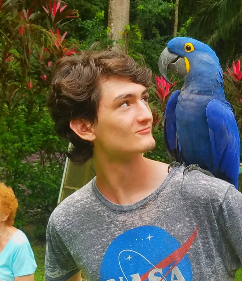 Boy with Macaw on Shoulder