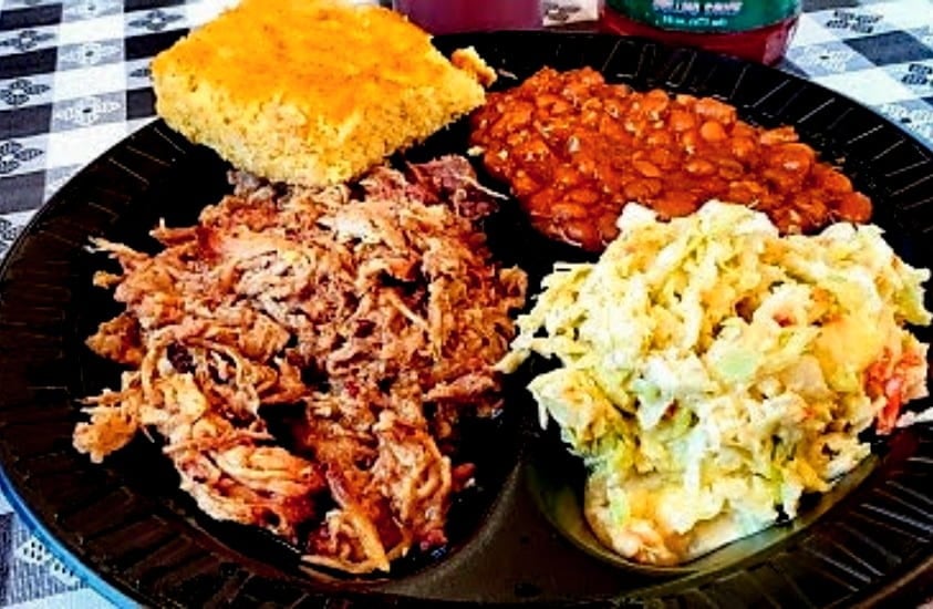 A plate of BBQ, beans, coleslaw and cornbread from Smokey Dave's BBQ