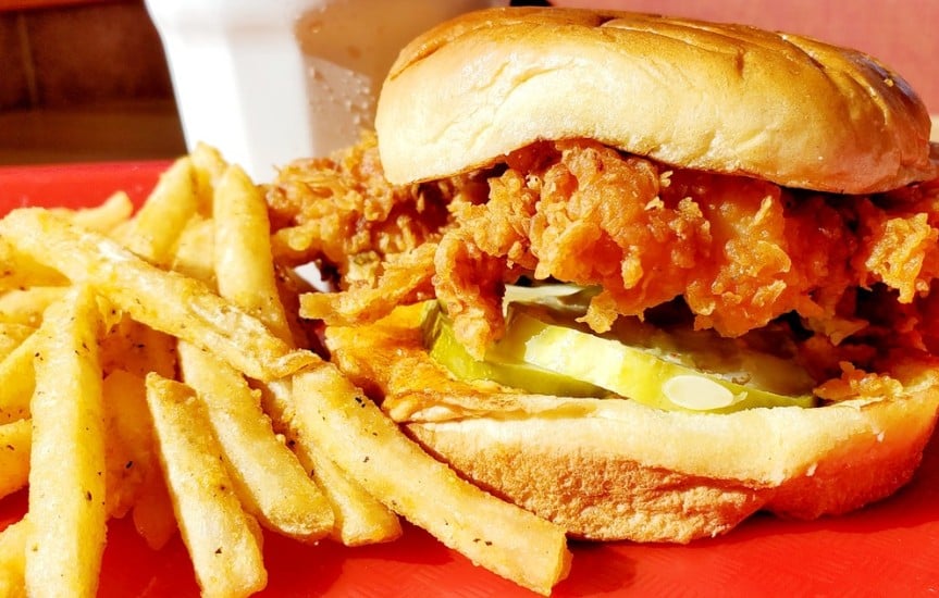 Popeye's New Spicy Chicken Sandwich with fries and drink.