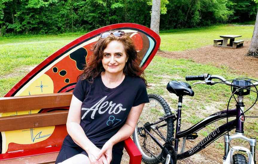 Kristen with her Schwinn on Neuse River Trail Raleigh NCBike Sitting On Bench