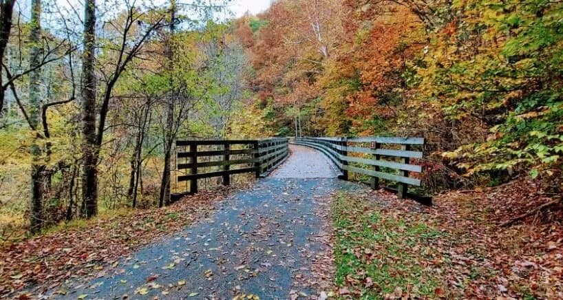 Bridge on Virginia Creeper Trail in the Fall with leaves changing colors.