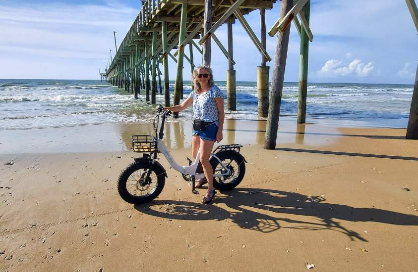 Kristen riding the foldable fat tire ebike Jaguarundi at the beach