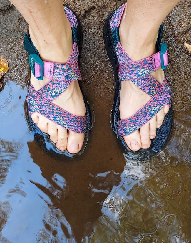 Kristen wading in Chacos sandals