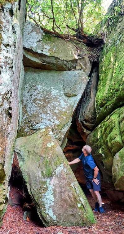 Gary looking at how tall the sandstone boulders are at The Channels near Abingdon, VA